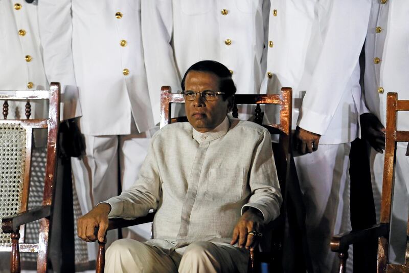 Sri Lanka's President Maithripala Sirisena waits next to Navy officers for a group photo during a commissioning handover ceremony of the P 626 ship by U.S. at the main port in Colombo, Sri Lanka June 6, 2019. Picture taken June 6, 2019. REUTERS/Dinuka Liyanawatte