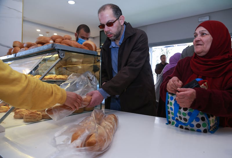 Customers at a bakery in Tunisia's capital Tunis. The IMF says the Covid-19 pandemic and war in Ukraine are adding to the structural challenges facing the country. AFP