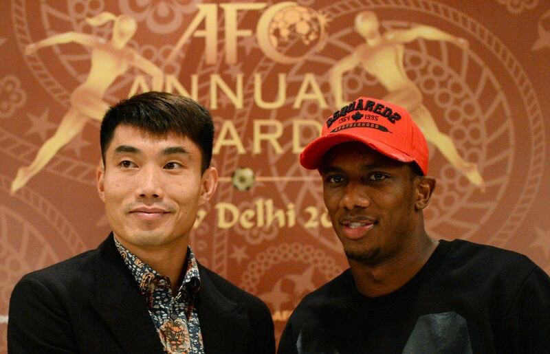 Ahmed Khalil, right, alongside fellow AFC Player of the Year nominee Zheng Zhi. Sajjad Hussain / AFP