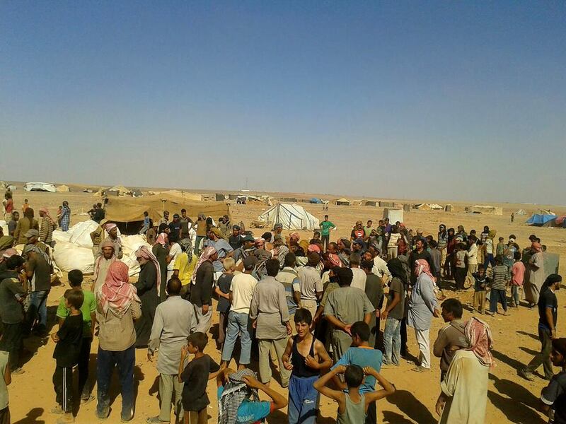 Community leaders distribute paltry food and aid supplies at the Rukban camp. AP 