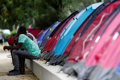 Minor migrants sit near tents at a migrant campsite housing about 100 adolescents, installed by Medecins Sans Frontieres (MSF - Doctors Without Borders) and four other humanitarian groups, in Paris, France, June 30, 2020. REUTERS/Gonzalo Fuentes
