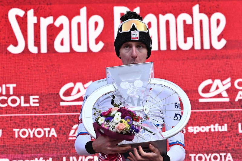 Tadej Pogacar on the podium after winning the one-day classic Strade Bianche. AFP
