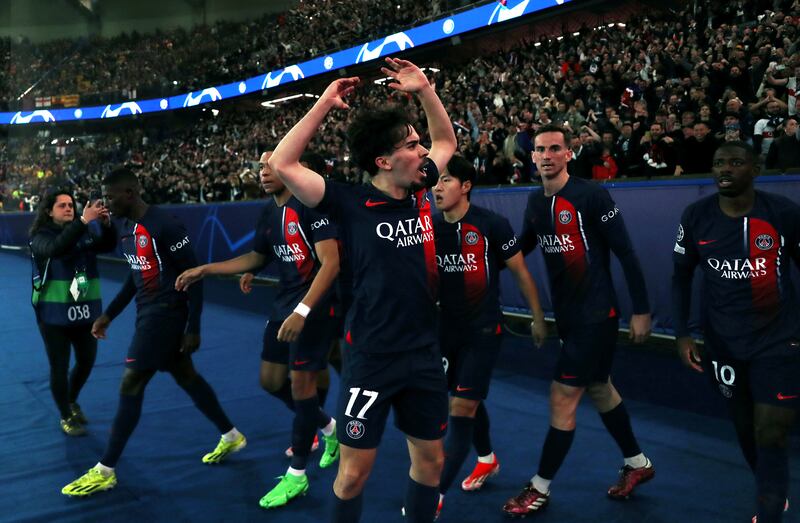 Vitinha and PSG teammates celebrate in front of the fans after taking a 2-1 lead against Barcelona. Getty Images