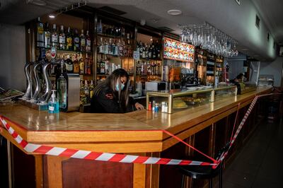 A bar counter is sealed off to prevent contact with customers at Usera neighborhood in Madrid, Spain, Tuesday, Sept. 22, 2020. Madrid is poised to extend its restrictions on movement to more neighborhoods, due to a surge in new cases in other districts and despite an outcry from residents over discrimination. (AP Photo/Manu Fernandez)