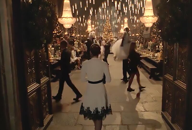 Emma Watson arrives at Hogwarts and steps into a Yule Ball-like party in the Great Hall.