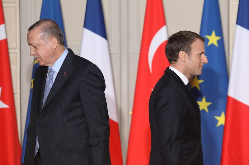 (FILES) In this file photo taken on January 5, 2018, French President Emmanuel Macron (R) and Turkish President Recep Tayyip Erdogan walk during a joint press conference, at the Elysee Palace in Paris. The French government will summon the Turkish envoy in Paris for talks after what it termed "insults" by Turkey's President Recep Tayyip Erdogan, who accused Emmanuel Macron of suffering "brain death", the president's office said on November 29, 2019. / AFP / POOL / LUDOVIC MARIN
