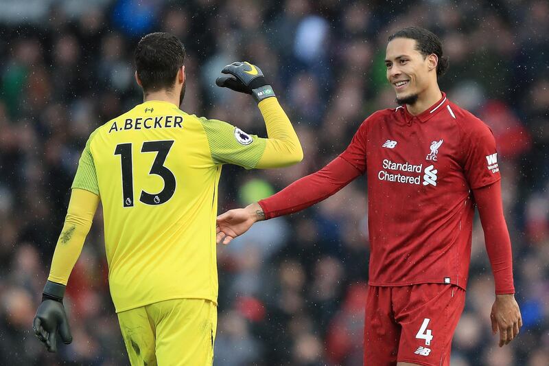 18 points - the amount United currently trail rivals Liverpool who are top of the Premier League. Pictured  Alisson and Virgil van Dijk. Getty Images
