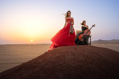 Their success has led to loans of beautiful gowns for performances and photo shoots, such as those designed by the luxury Egyptian couture house Maram Borhan worn standing on sand dunes for the Arabesque album cover. Photo: The Ayoub Sisters