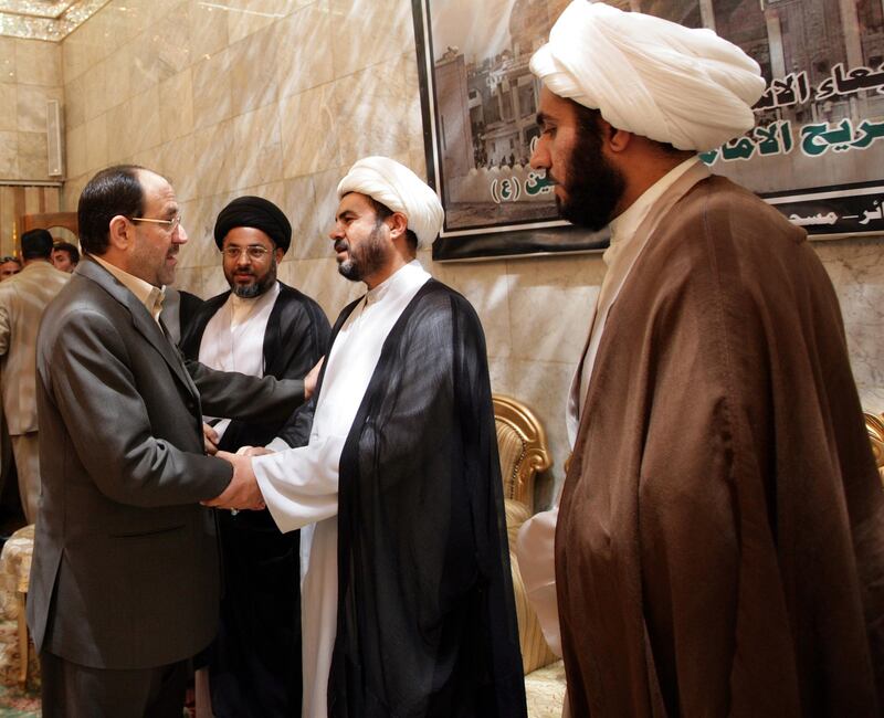 Prime minister Nouri Al Maliki shakes hands with a cleric while on a visit to the holy Shiite city of Karbala, Iraq, on on August 30, 2007. Shiite cleric Moqtada Al Sadr had ordered his Mahdi Army militia to suspend its activities for six months after clashes in Karbala in which at least 52 people were killed.