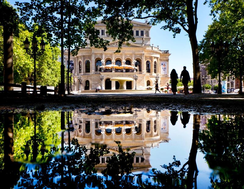 Frankfurt's Old Opera is reflected in a puddle. Michael Probst / AP Photo