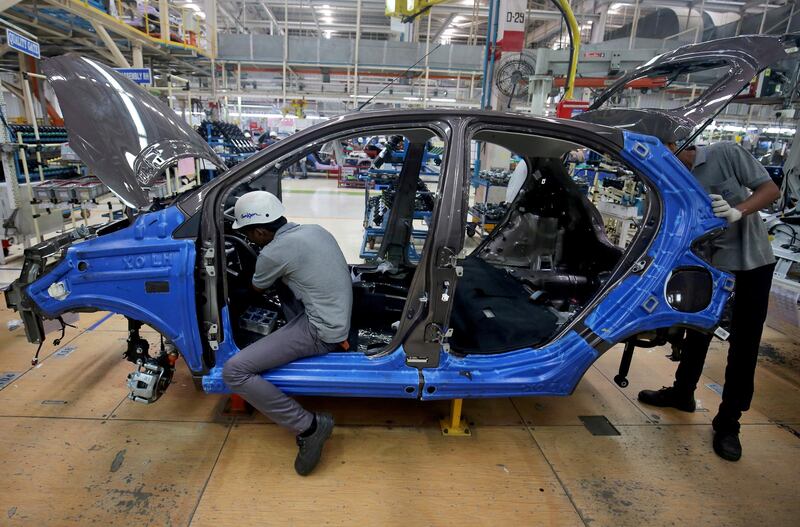 FILE PHOTO: Workers assemble a Tata Tiago car inside the Tata Motors car plant in Sanand, on the outskirts of Ahmedabad, India, August 7, 2018. REUTERS/Amit Dave/File Photo