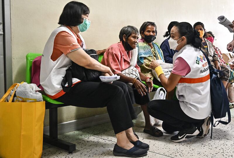 Mental health counsellors speak to relatives of survivors, injured in a mass shooting by a former police officer at a nursery, at a hospital in Thailand's Nong Bua Lam Phu. AFP