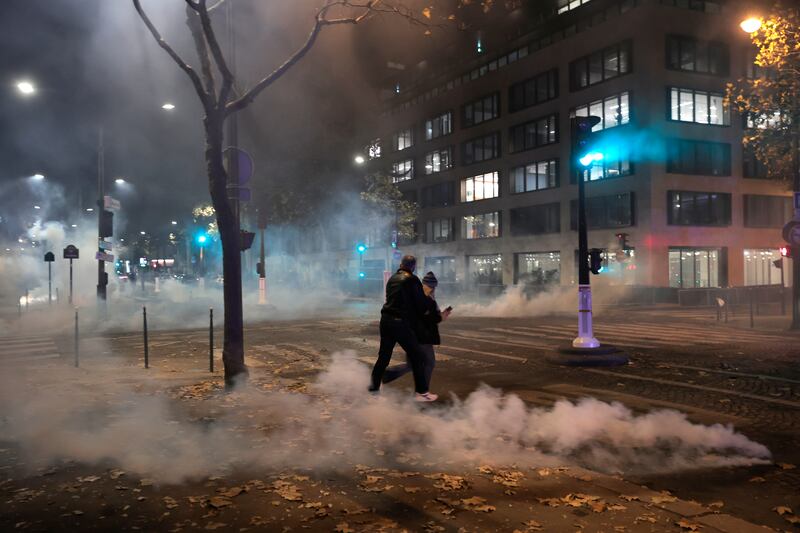 Tear gas was used to disperse crowds in Paris. AP