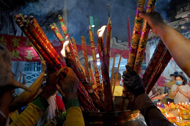 Cambodian devotees offer incense sticks at a temple to mark the start of the Lunar New Year in Ta Khmao, Kandal province. AFP