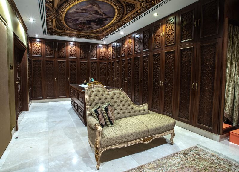 A walk-in closet keeps up the vintage opulence theme.