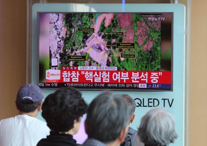 People watch a TV news reporting about a possible nuclear test conducted by North Korea ,at the Seoul Railway station in Seoul, South Korea, Sunday, Sept. 3, 2017. South Korean officials say they have detected an artificial 5.6 magnitude quake in North Korea and are analyzing whether Pyongyang has conducted its sixth nuclear test. The signs read " South Korean JCS said analyzing nuclear test". (AP Photo/Ahn Young-joon)