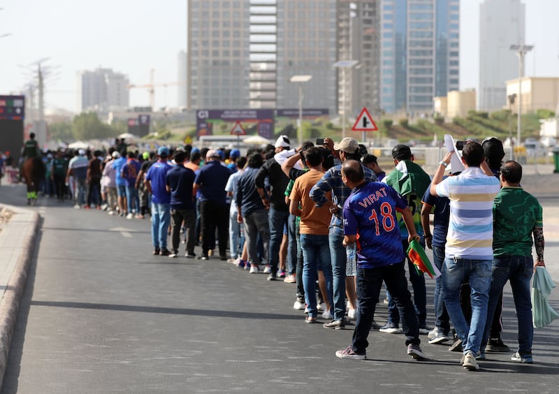 Fans queue to get into the stadium before the game.