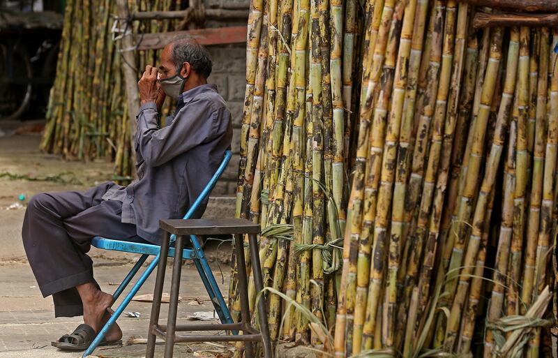 A sugarcane vendor waits for customers after lockdown measures are eased in Bangalore, India.