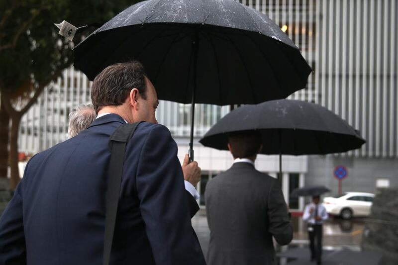 Office-goers had to bring out the umbrellas on Tuesday. Delores Johnson / The National