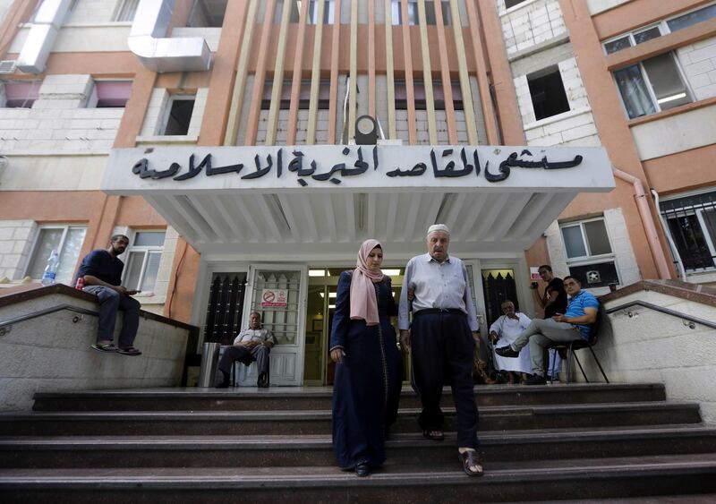 Palestinians leave the Makassed hospital in east Jerusalem.  AP