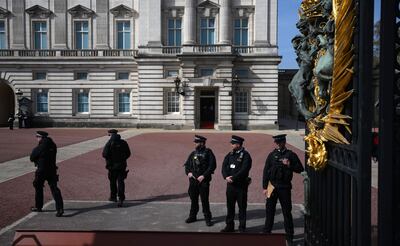 Police officers on duty at an entrance to Buckingham Palace in central London, on Wednesday. AFP