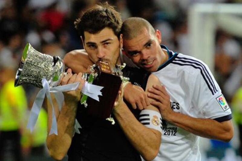 Real Madrid captain Iker Casillas and teammate Pepe celebrate with the Spanish Super Cup