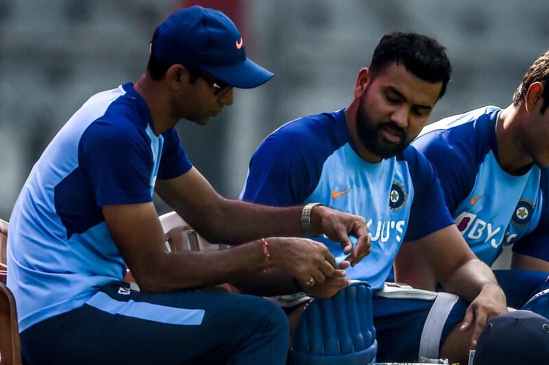 India's team physiotherapist Nitin Patel looks at Rohit Sharma's thumb following an injury during training in Mumbai. AFP