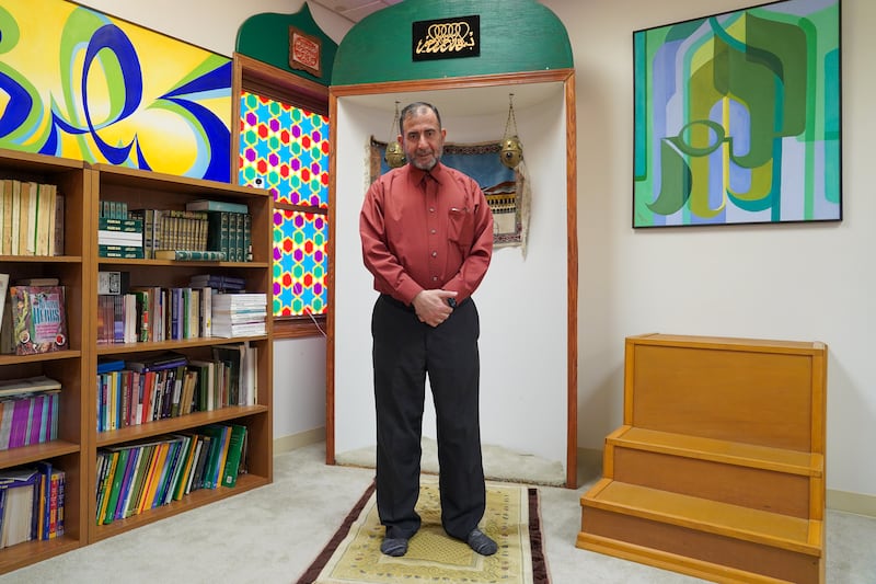 Imam Taha Tawil poses inside the Mother Mosque of America.