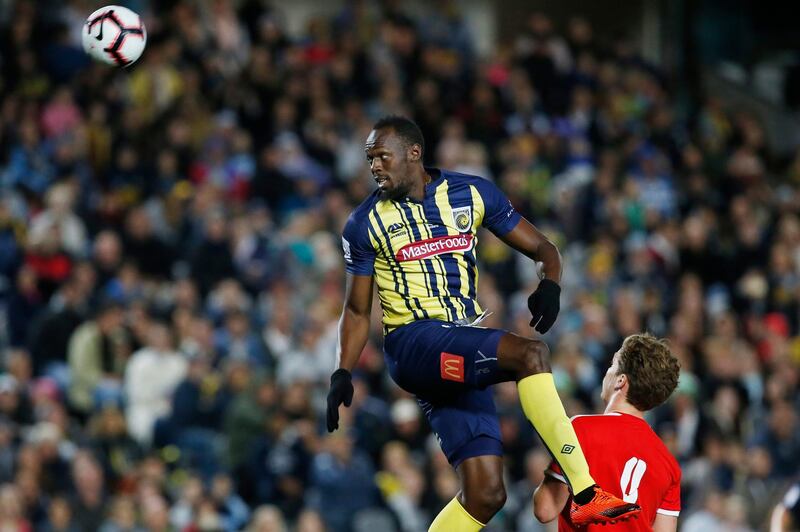 Usain Bolt goes up for a header during a friendly trial match between the Central Coast Mariners and the Central Coast Select in Gosford, Australia, Friday, Aug. 31, 2018. Bolt, who holds the world records for the 100- and 200-meter sprints and is an eight-time Olympic gold medalist, is hoping to earn a contract with the Mariners for the 2018-19 season in Australia's top-flight competition. (AP Photo/Steve Christo)