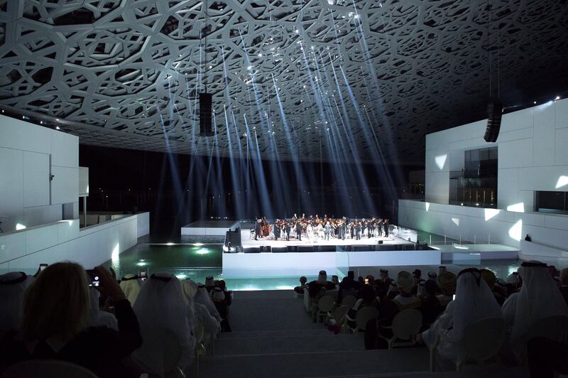 SAADIYAT ISLAND, ABU DHABI, UNITED ARAB EMIRATES -November 08, 2017: Audience members watch an orchestral performance during the opening ceremony of the Louvre Abu Dhabi.

( Hamad Al Mansoori for The Crown Prince Court - Abu Dhabi )
---