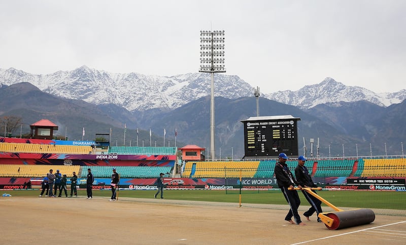 DHARAMSALA, INDIA - MARCH 24: Groundsmen prepare the pitch ahead of the Women's ICC World Twenty20 India 2016 match between England and the West Indies at the HPCA Stadium on March 24, 2016 in Dharamsala, India. (Photo by Matthew Lewis-ICC/ICC via Getty Images)