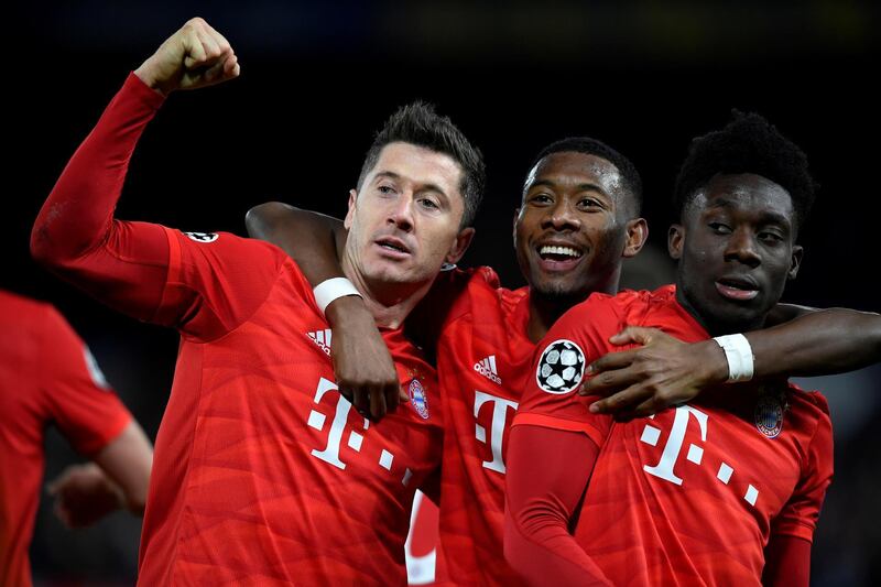 Bayern Munich's Robert Lewandowski celebrates scoring their third goal with teammates David Alaba and Alphonso Davies. Reuters