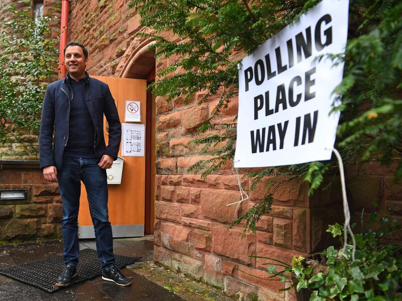 Scottish Labour party leader Anas Sarwar poses as he arrives to deliver a postal vote at a polling station in Glasgow. AFP