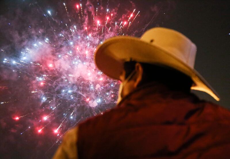 A supporter of leftist school teacher Pedro Castillo watches fireworks during celebrations  in downtown Lima following the official proclamation of him as Peru’s president-elect.