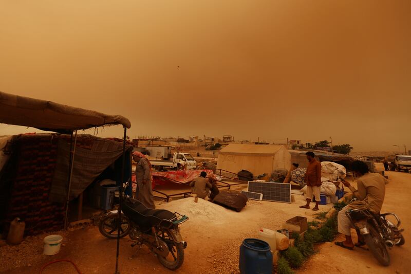 The rebel-held town of Dana is coated in dust and sand.