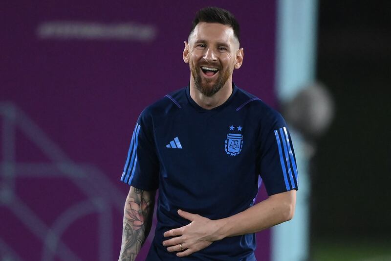 Argentina forward Lionel Messi laughs during a training session at Qatar University ahead of the World Cup final against France. AFP
