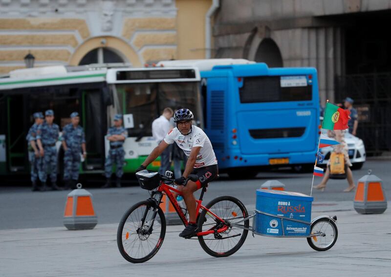 Portuguese cyclist Helder Batista, who arrived in Russia's capital to attend the 2018 FIFA World Cup, rides his bike in central Moscow, Russia June 18, 2018. REUTERS/Tatyana Makeyeva