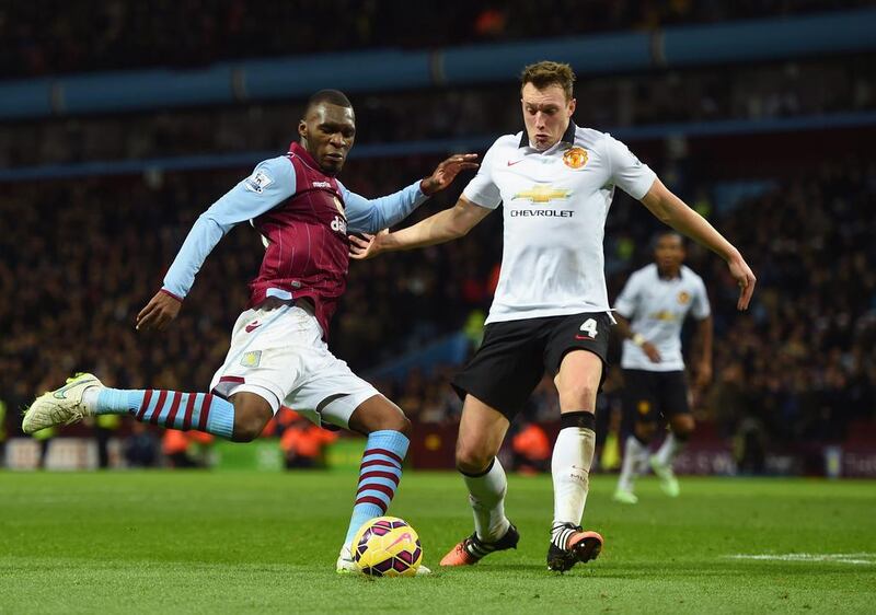 Christian Benteke, left, of Aston Villa is closed down by Jonny Evans of Manchester United during their English Premier League match at Villa Park on December 20, 2014 in Birmingham, England. Michael Regan / Getty Images