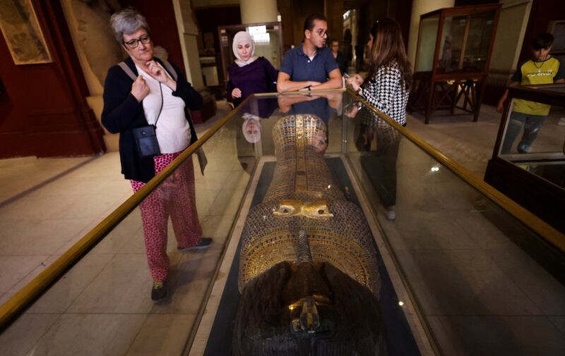 Visitors to the Egyptian Museum in Cairo discuss an exhibit. Reuters