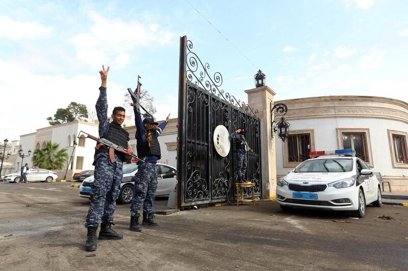 As Field Marshal Khalifa Haftar's forces fought Benghazi militiamen in central Libya on March 15, 2017, two militia alliances continued to clash for a third day in Tripoli. Here, fighters loyal to the UN-backed government flash victory signs outside the Guest Palace, a complex of luxury villas close to the Rixos Hotel. Mahmud Turkia / AFP 

