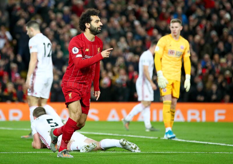 LIVERPOOL, ENGLAND - JANUARY 02: Mohamed Salah of Liverpool celebrates after scoring his team's first goal as Dean Henderson of Sheffield United reacts during the Premier League match between Liverpool FC and Sheffield United at Anfield on January 02, 2020 in Liverpool, United Kingdom. (Photo by Clive Brunskill/Getty Images)