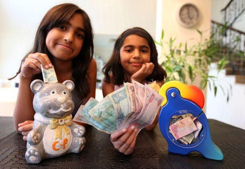Eleven-year-old Chantelle Popat, left, and her 8-year-old sister, Natalina, have pledged to spend less pocket money so they can save more.