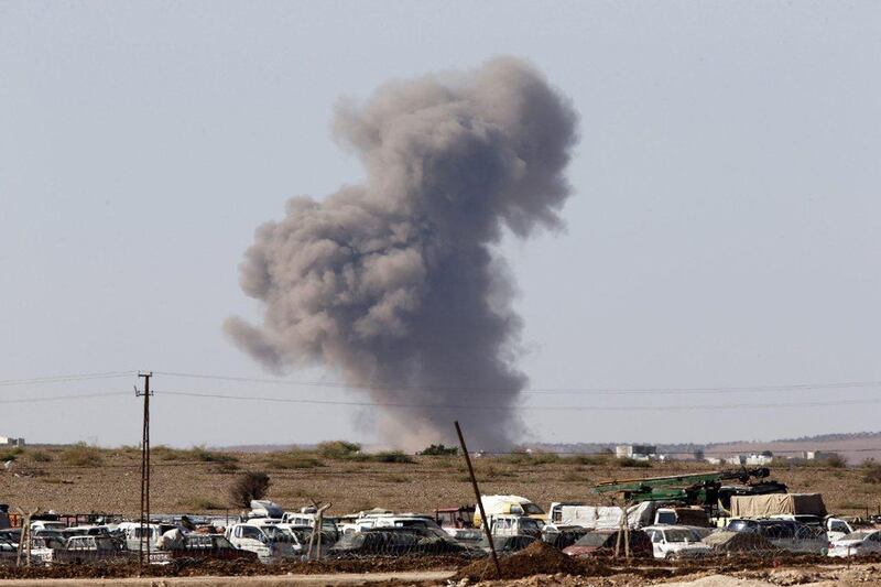 Smoke rises from the Syrian town of Kobani after an air raid, seen from near the Mursitpinar border crossing on the Turkish-Syrian border. Unit Bektas / Reuters