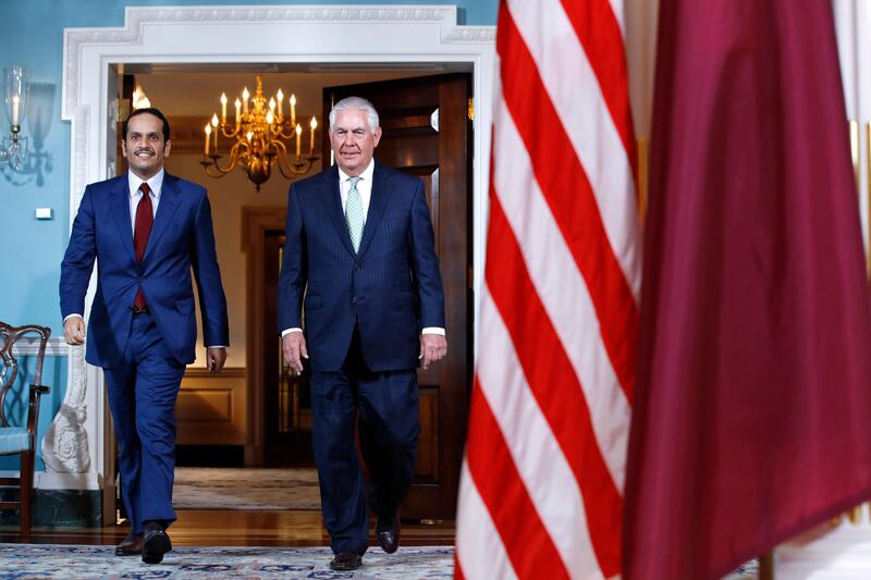 US secretary of state Rex Tillerson walks with Qatar's foreign minister Sheikh Mohammed bin Abdulrahman Al Thani. Washington is likely to push for an early resolution based on Gulf Arab reconciliation. AP Photo / File