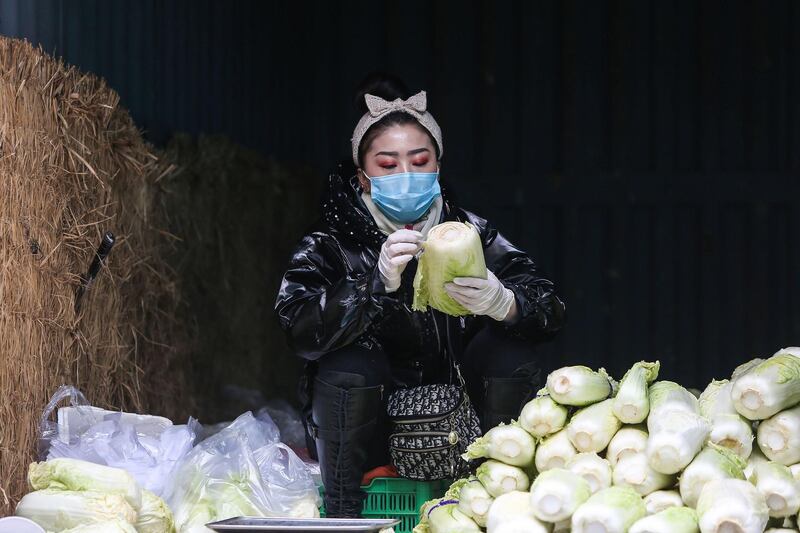 A vendor waits for customers at a market in Shenyang in China's northeastern Liaoning province. AFP