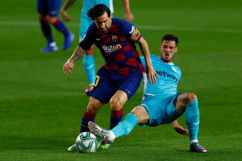 Barcelona's Lionel Messi, left, is challenged by Leganes' Ruben Perez. AP Photo