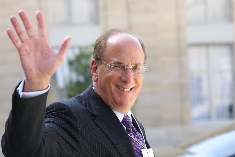 (FILES) In this file photo taken on July 10, 2019, Chairman and CEO of BlackRock, Larry Fink waves as he leaves a meeting about climate action investments at the Elysee Palace in Paris. BlackRock, sometimes called the most powerful company you have never heard of, has grown exponentially since its founding in 1988, especially since the 2008 financial crisis.  The company has been seen as a shadowy potential beneficiary of the French government's controversial pension system changes by critics of French President Emmanuel Macron. / AFP / Ludovic MARIN
