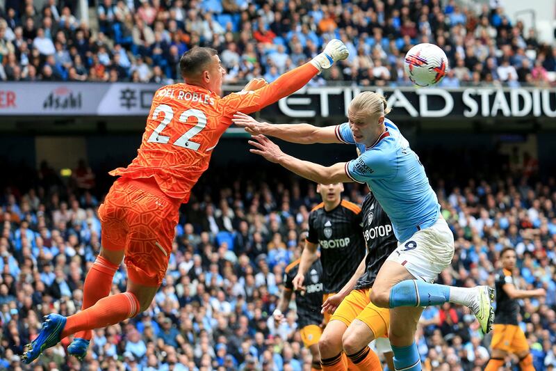Leeds United goalkeeper Joel Robles punches the ball clear from Manchester City's Erling Haaland. AFP