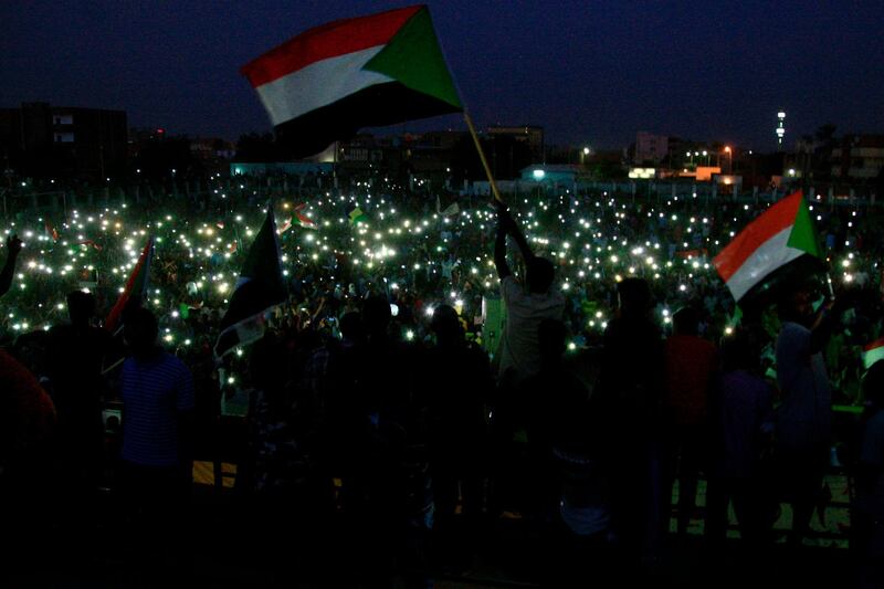 Sudanese protesters take part in a vigil in the capital Khartoum's northern district of Bahri, to mourn dozens of demonstrators killed last month in a brutal raid on a Khartoum sit-in. AFP