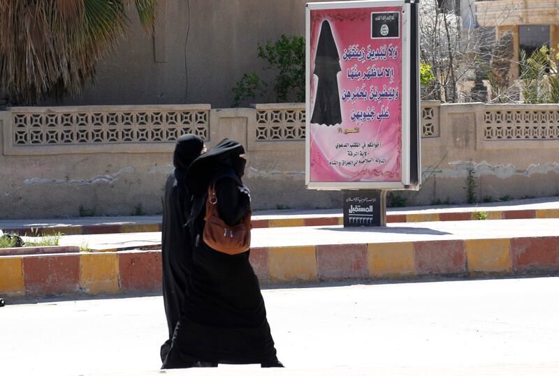 A billboard carries a verse from the Quran urging women to wear a hijab in the northern Syrian province of Raqqa in March 2014. All photos: Reuters